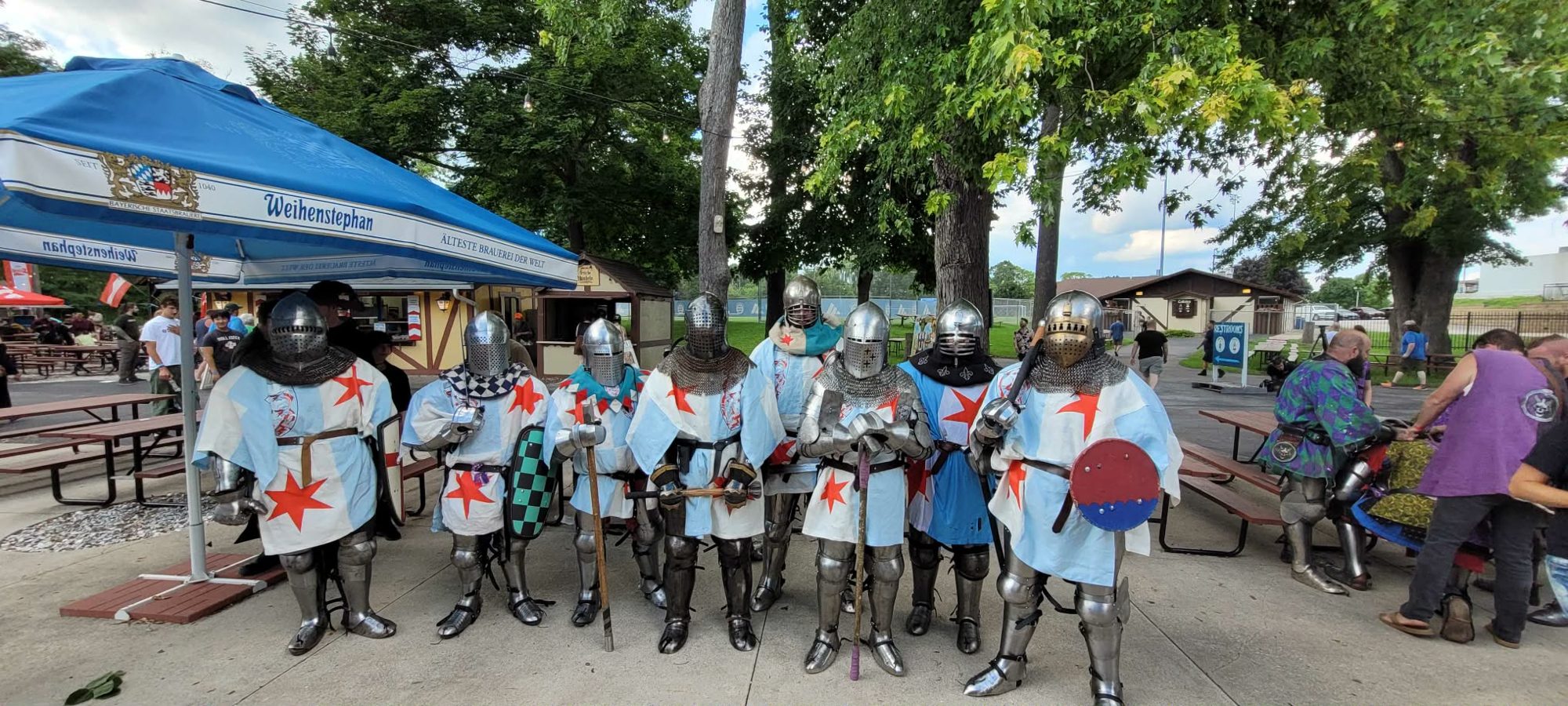 Chicago Hydras fighters lined up in full armor and Chicago-flag tabards