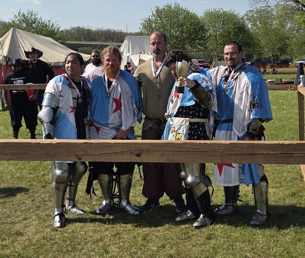Hydras fighters with medals and a trophy after a tournament